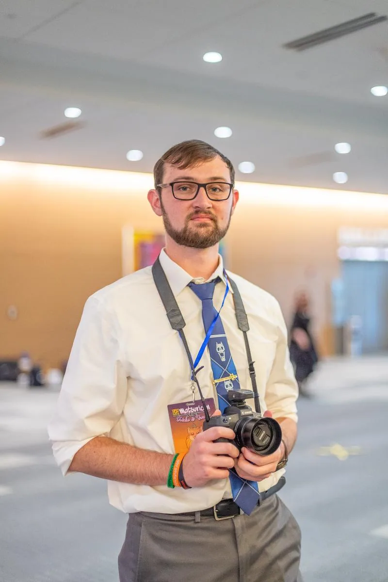 Portrait of William Pelphrey holding a camera.